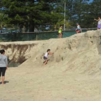 Children are having fun on the escarpment caused by erosion
