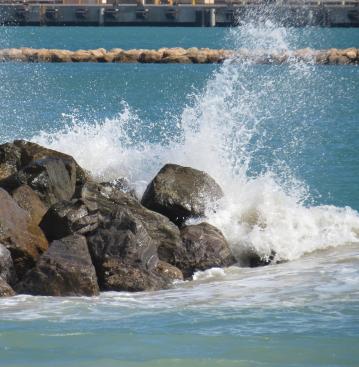 The ocean meets the rocks in a turbulent burst of spray